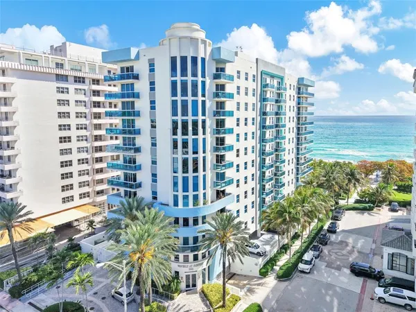 a view of hallway with furniture and windows