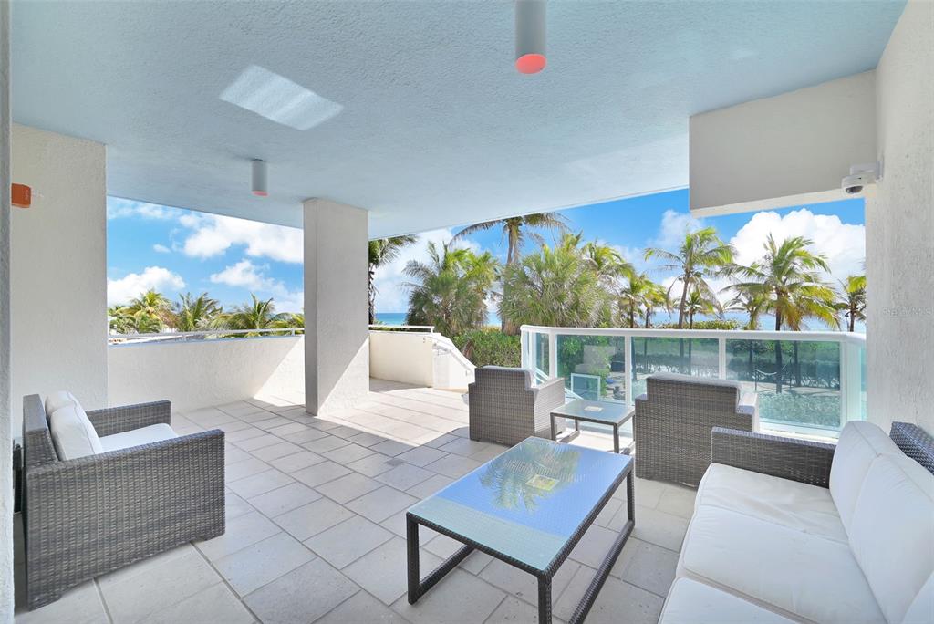 9201 Collins Avenue, Unit 821 Surfside, FL 33154 - Photo 23 of 60 a living room with patio furniture and a potted plants