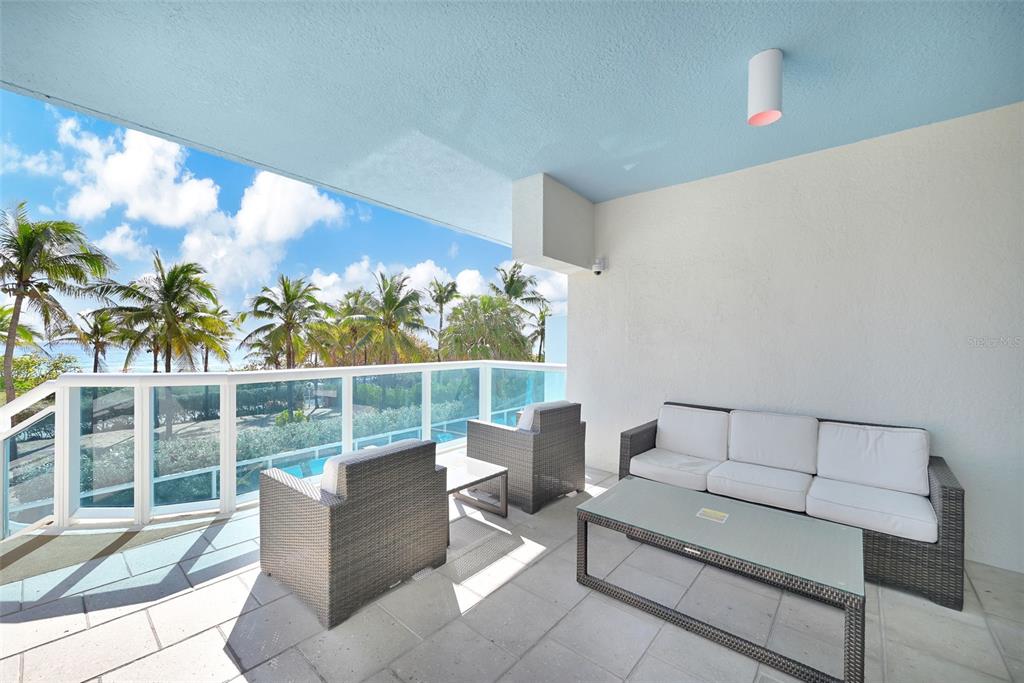 9201 Collins Avenue, Unit 821 Surfside, FL 33154 - Photo 24 of 60 a balcony with furniture and a potted plant