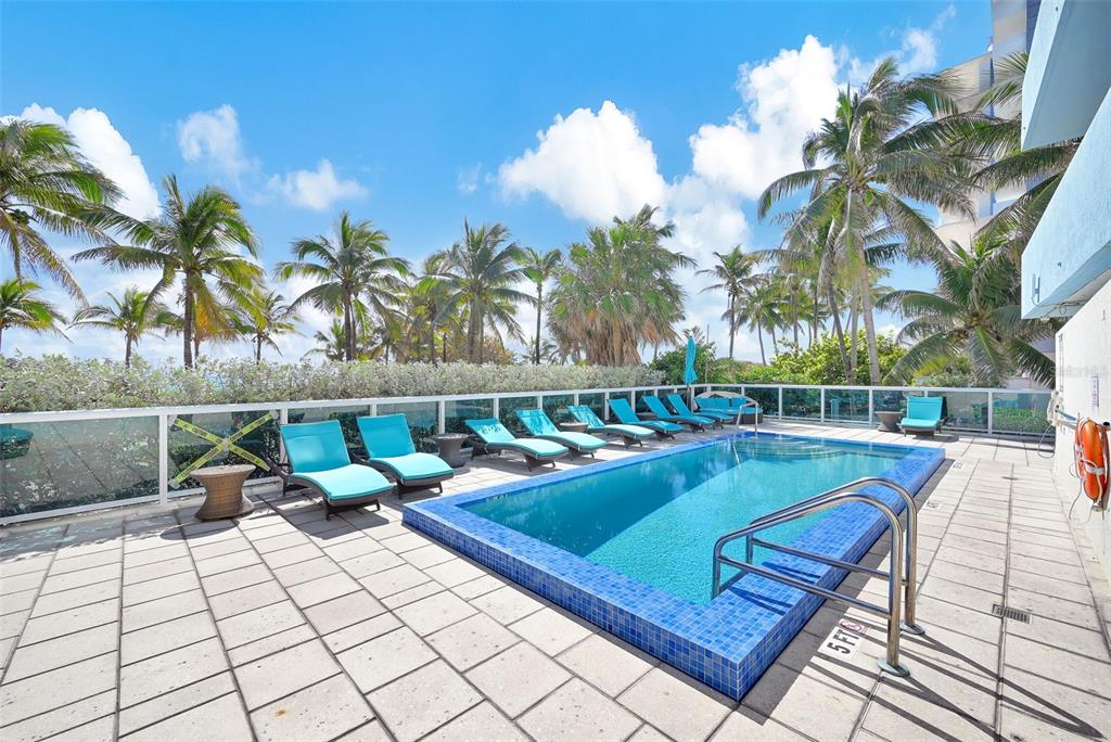 9201 Collins Avenue, Unit 821 Surfside, FL 33154 - Photo 26 of 60 a view of swimming pool with seating space