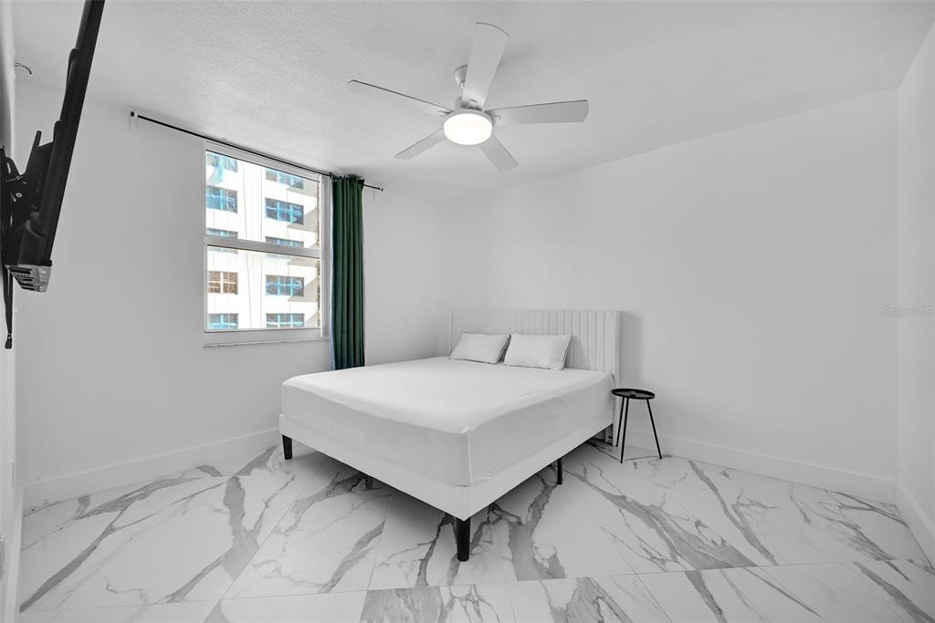 9201 Collins Avenue, Unit 821 Surfside, FL 33154 - Photo 31 of 60 a bedroom with a bed and a window
