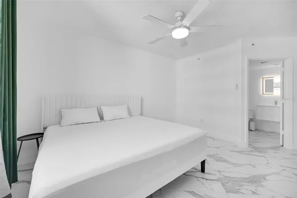 a large white bed in a white room