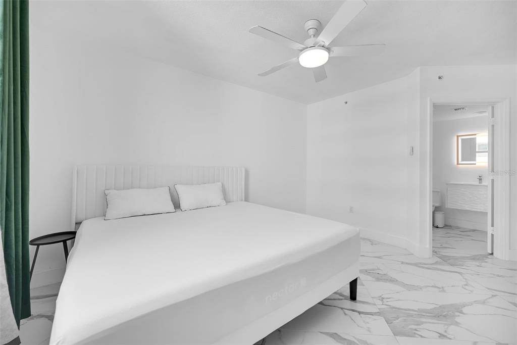 9201 Collins Avenue, Unit 821 Surfside, FL 33154 - Photo 34 of 60 a bedroom with a bed and a chandelier