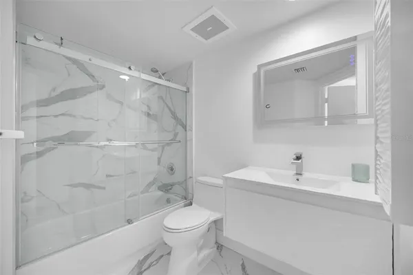 a kitchen with stainless steel appliances and refrigerator