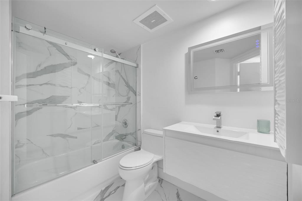 9201 Collins Avenue, Unit 821 Surfside, FL 33154 - Photo 42 of 60 a bathroom with a sink toilet and shower