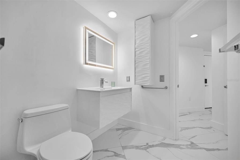 9201 Collins Avenue, Unit 821 Surfside, FL 33154 - Photo 43 of 60 a bathroom with a toilet sink and shower