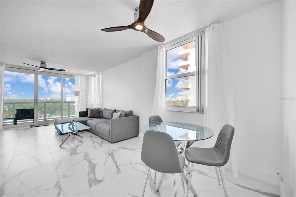 9201 Collins Avenue, Unit 821 Surfside, FL 33154 - Photo 51 of 60 a living room with furniture and a large window