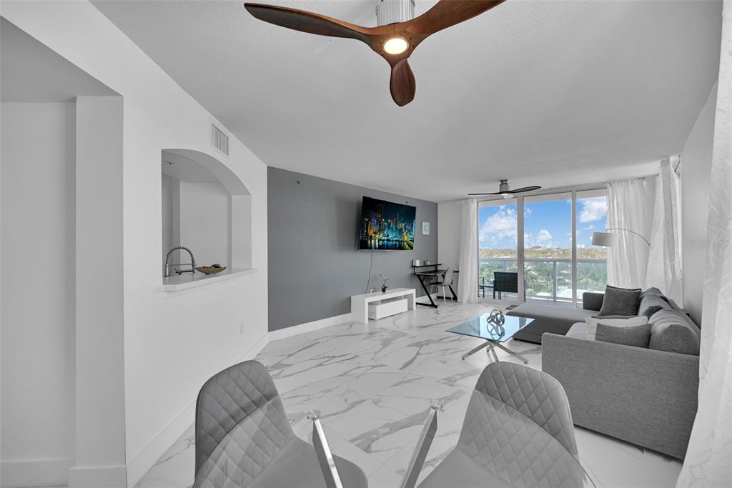 9201 Collins Avenue, Unit 821 Surfside, FL 33154 - Photo 52 of 60 a living room with furniture and a flat screen tv