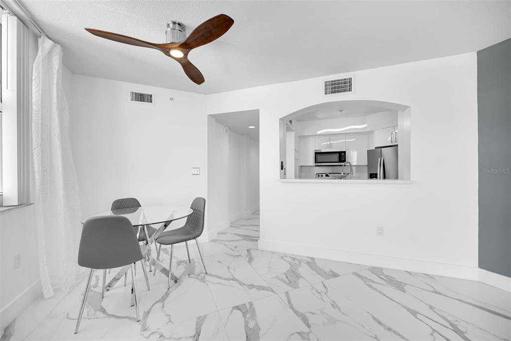9201 Collins Avenue, Unit 821 Surfside, FL 33154 - Photo 54 of 60 a view of kitchen and dining room with wooden floor