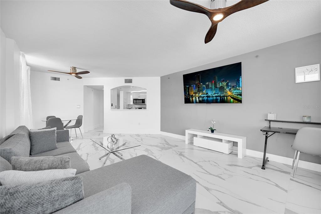 9201 Collins Avenue, Unit 821 Surfside, FL 33154 - Photo 55 of 60 a living room with furniture and a flat screen tv