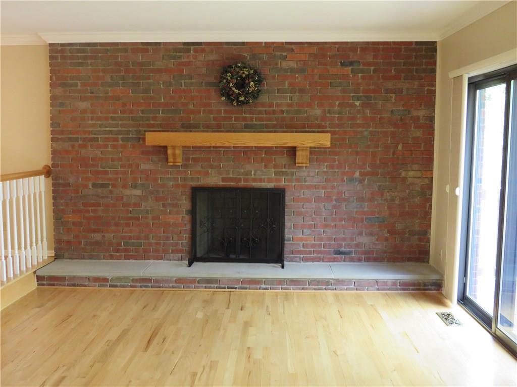8341 Post Road Allison Park, PA 15101 - Photo 11 of 24 Again, Look at those floors! The first of two fire places. The living room is off of the dining room. Two sets of sliding glass doors lead to the relaxing deck. ( feature : The blinds on the doors open and close on both sides.)