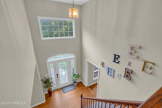 a living room with furniture a fireplace and a flat tv screen next to a window