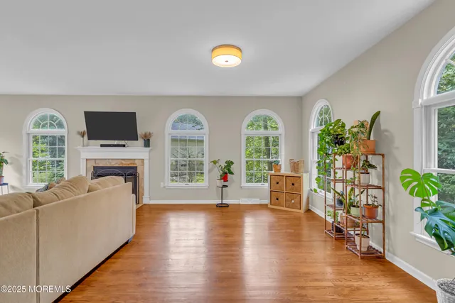 a living room with furniture and a wooden floor