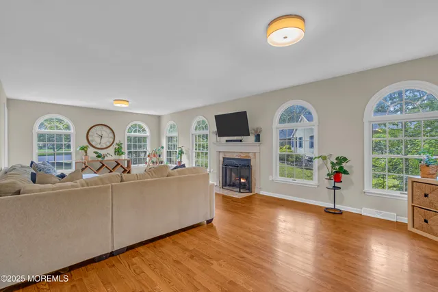 a bathroom with a toilet a sink a vanity and a window