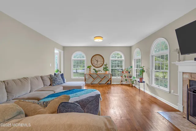 a bedroom with a bed flat screen tv and a large window