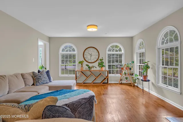 a spacious bedroom with a bed and a flat screen tv