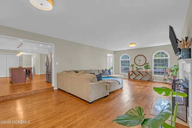 a spacious bedroom with a bed and a flat screen tv