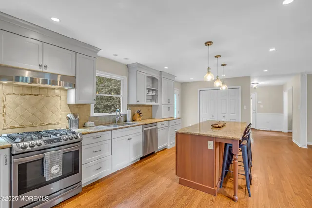 a view of a swimming pool with a yard and large trees
