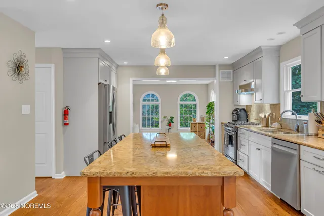 an aerial view of a house with a yard and lake view