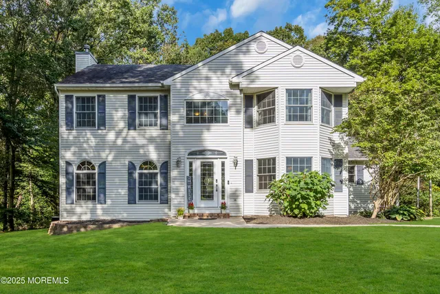 a view of an entryway with wooden floor and a potted plant