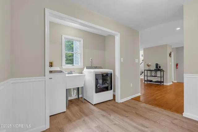 an aerial view of residential houses with outdoor space and trees