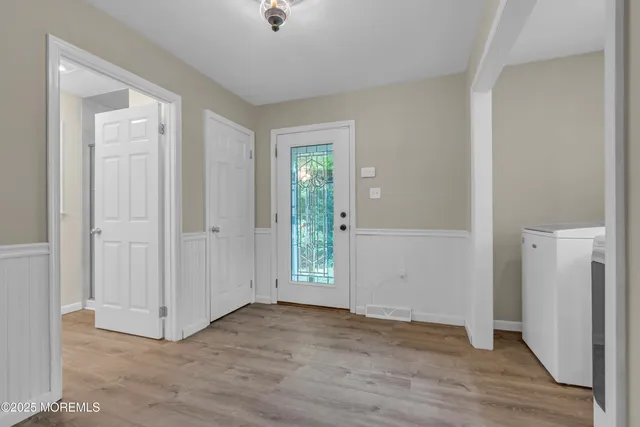 a view of a backyard with plants and large tree