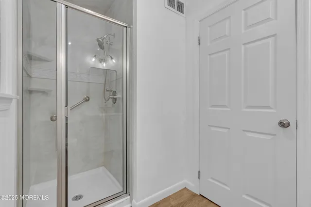 a view of a yard with plants and a bench