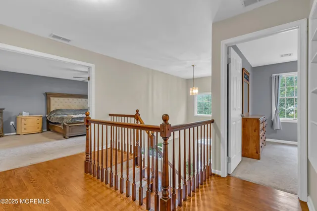 an aerial view of a house with a yard and lake view