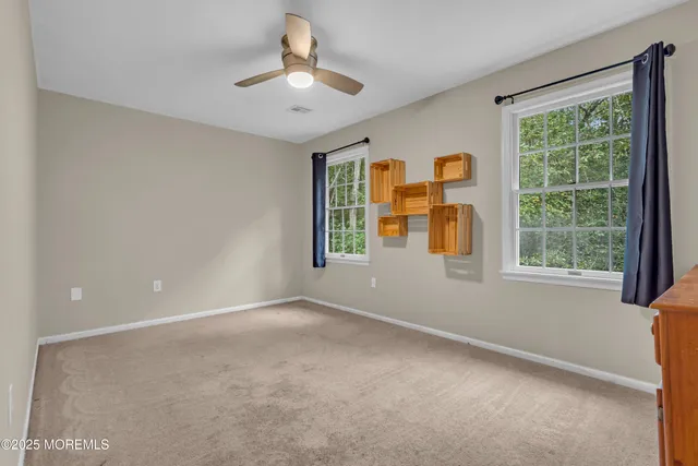 an aerial view of a house with a yard basket ball court and outdoor seating