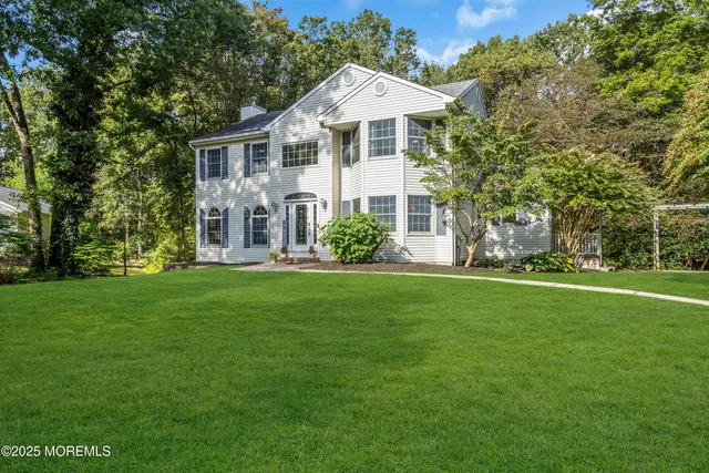 a view of a dining room with furniture a chandelier and wooden floor