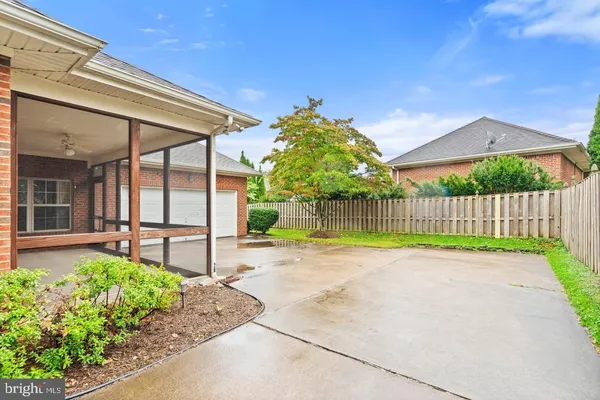 a view of a backyard with a garden and deck