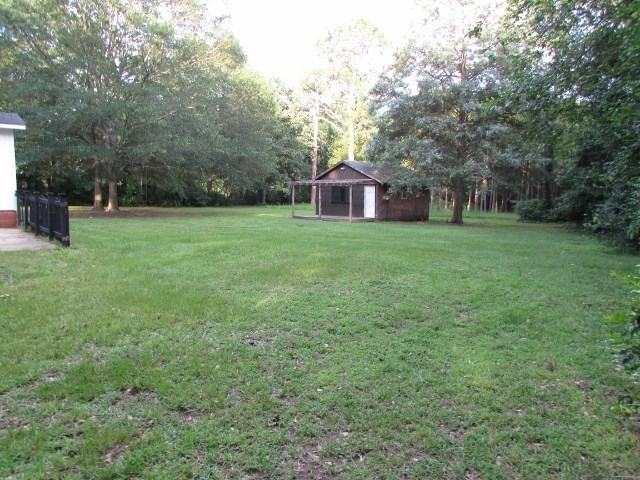 1730 Houston Lake Road Perry, GA 31069 - Photo 2 of 27 a view of a big yard with a house and large trees