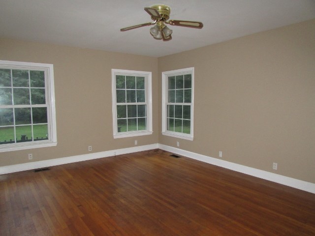 1730 Houston Lake Road Perry, GA 31069 - Photo 14 of 27 a view of an empty room with wooden floor and windows
