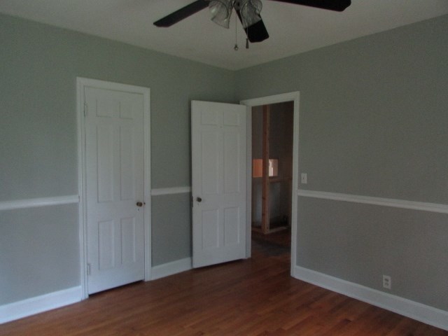 1730 Houston Lake Road Perry, GA 31069 - Photo 22 of 27 an empty room with wooden floor and ceiling fan