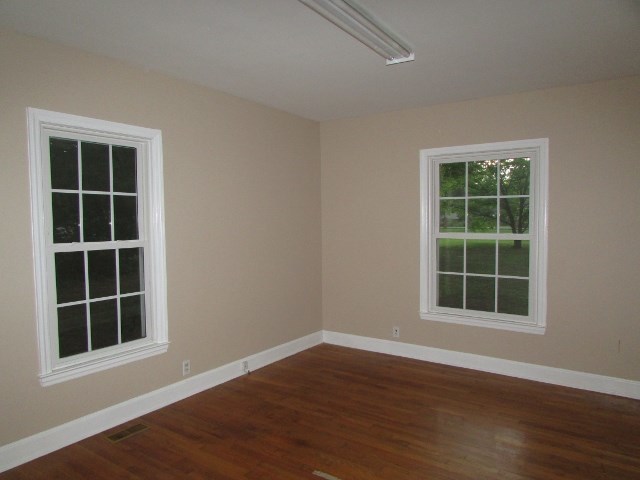 1730 Houston Lake Road Perry, GA 31069 - Photo 23 of 27 an empty room with wooden floor and windows