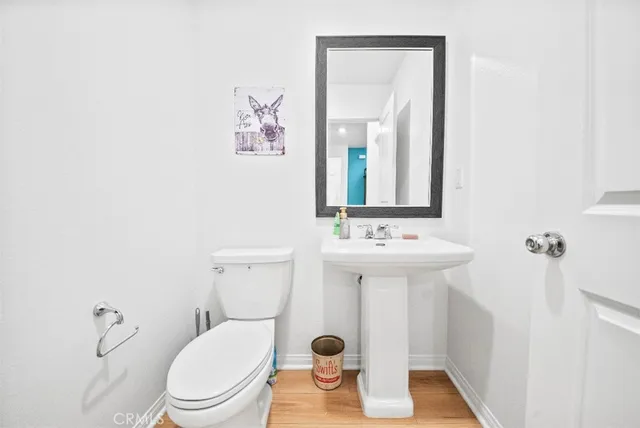 a bathroom with a sink a mirror and a toilet