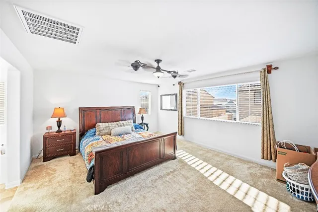 a bedroom with a bed couch and window