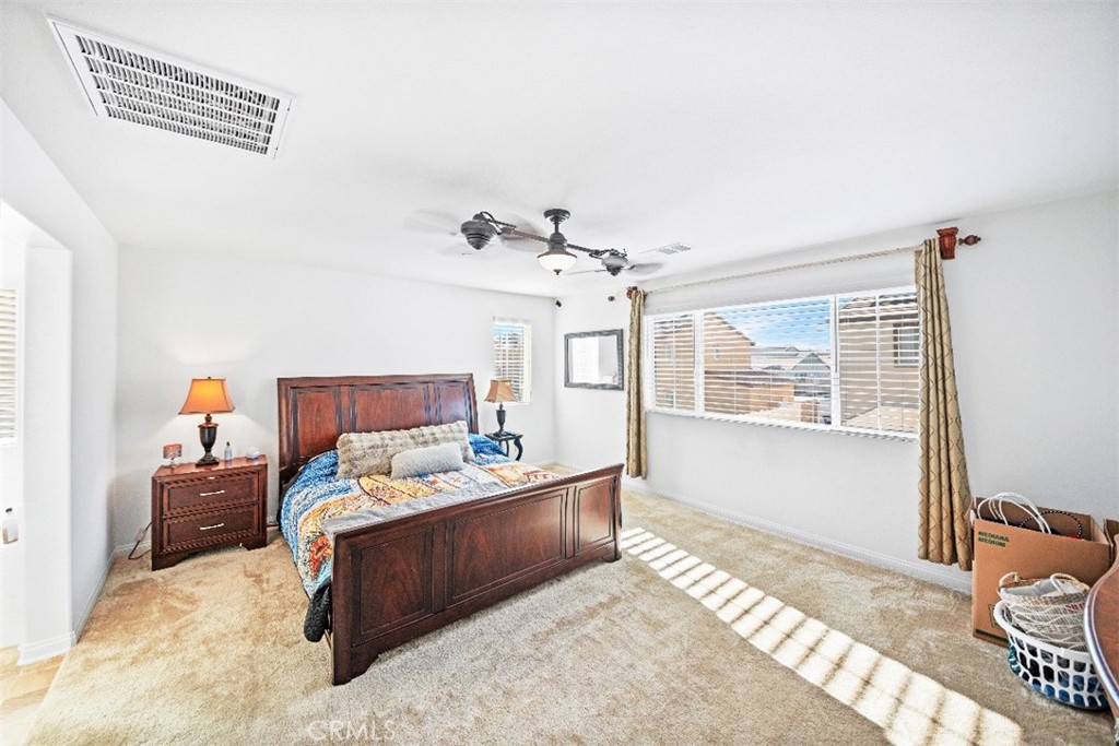 5066 Banjo Way Hemet, CA 92545 - Photo 16 of 27 a bedroom with a bed couch and window