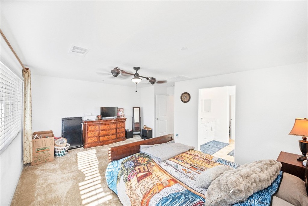 5066 Banjo Way Hemet, CA 92545 - Photo 17 of 27 a bedroom with a bed and wooden floor