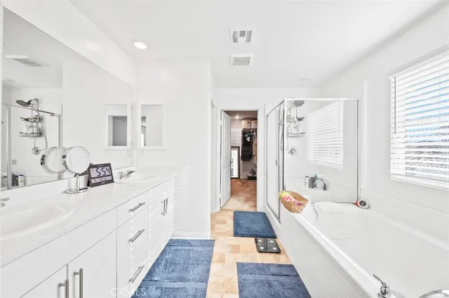 a bathroom with a tub sink and mirror