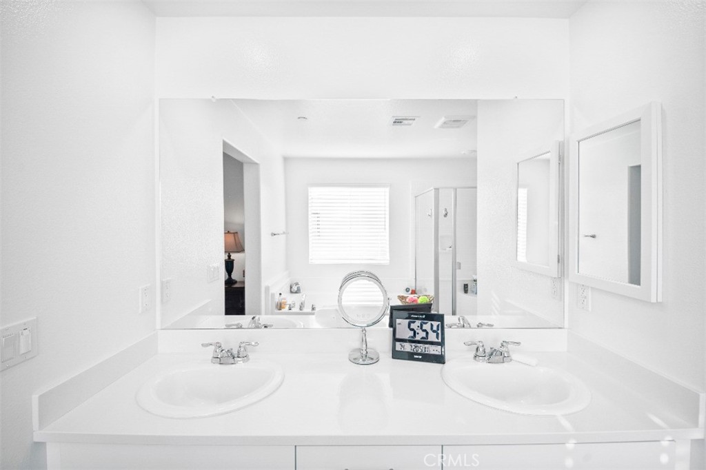 5066 Banjo Way Hemet, CA 92545 - Photo 21 of 27 a bathroom with a sink and a mirror