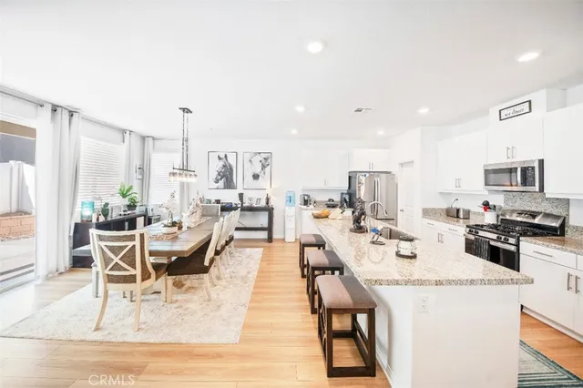 a living room with lots of furniture and kitchen view