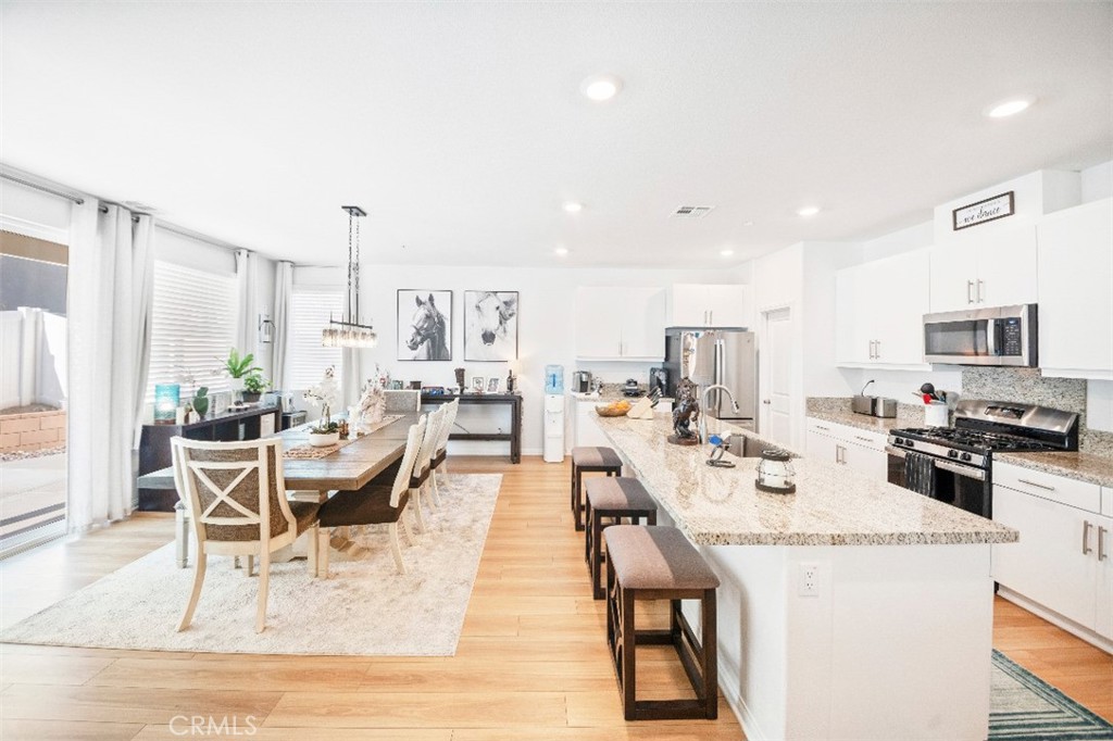 5066 Banjo Way Hemet, CA 92545 - Photo 8 of 27 a living room with lots of furniture and kitchen view