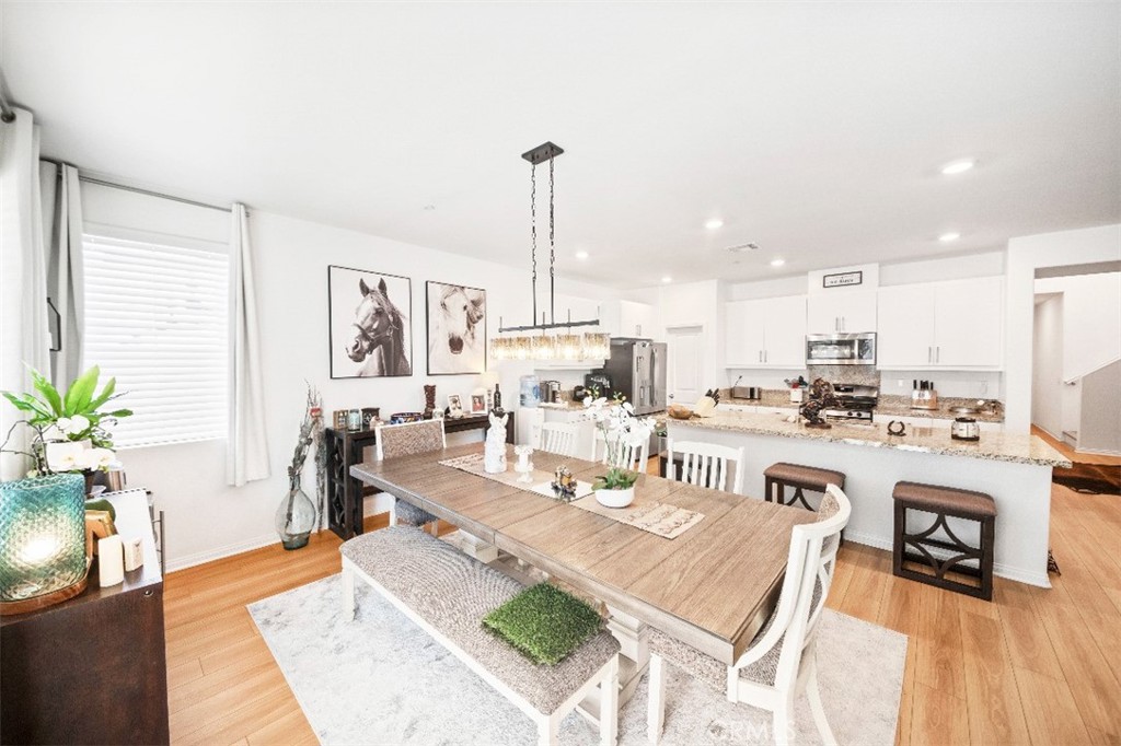 5066 Banjo Way Hemet, CA 92545 - Photo 9 of 27 a living room with lots of furniture and kitchen view