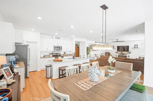 a large kitchen with a table and chairs