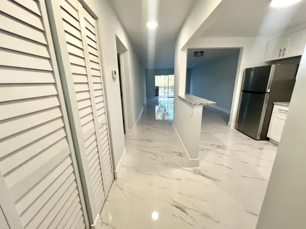 a view of an entryway with wooden floor