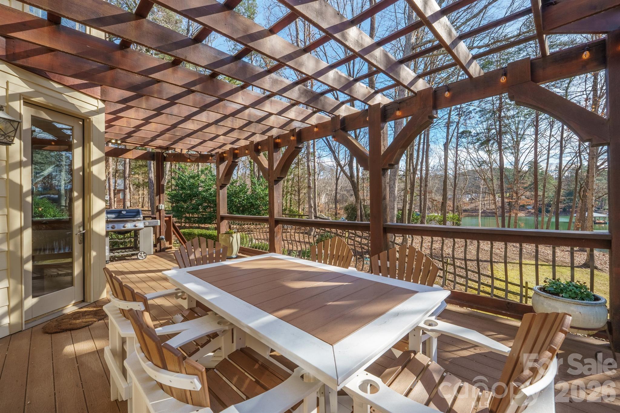 301 Agnew Road Mooresville, NC 28117 - Photo 12 of 42 a view of a patio with table and chairs and wooden fence