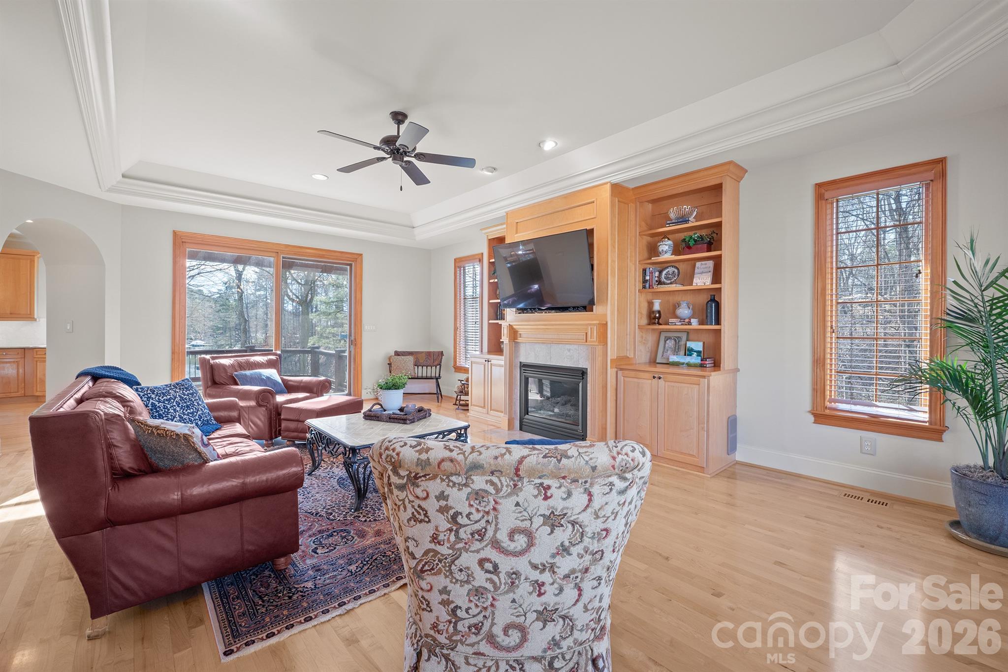 301 Agnew Road Mooresville, NC 28117 - Photo 18 of 42 a living room with furniture a fireplace and a large window