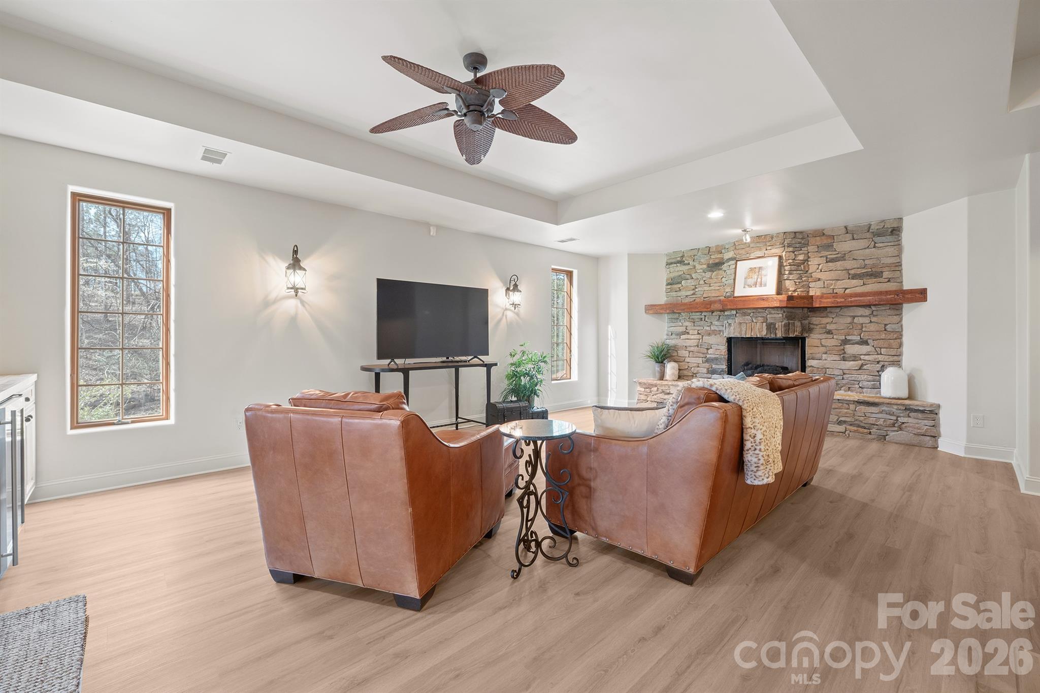 301 Agnew Road Mooresville, NC 28117 - Photo 22 of 42 a living room with furniture a flat screen tv and a fireplace