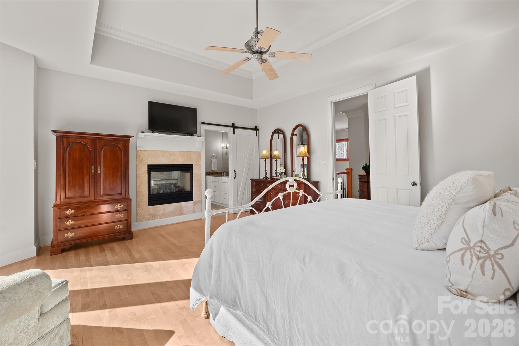 301 Agnew Road Mooresville, NC 28117 - Photo 31 of 42 a bedroom with a bed and a fireplace